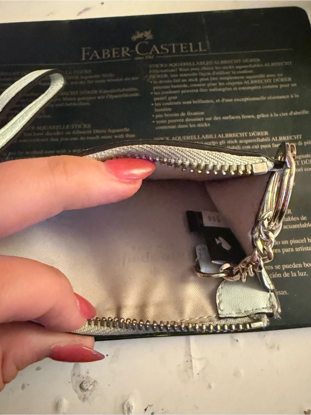 kate spade light blue pebbled leather wristlet with gold logo